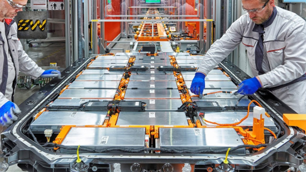 two workers looking at EV battery